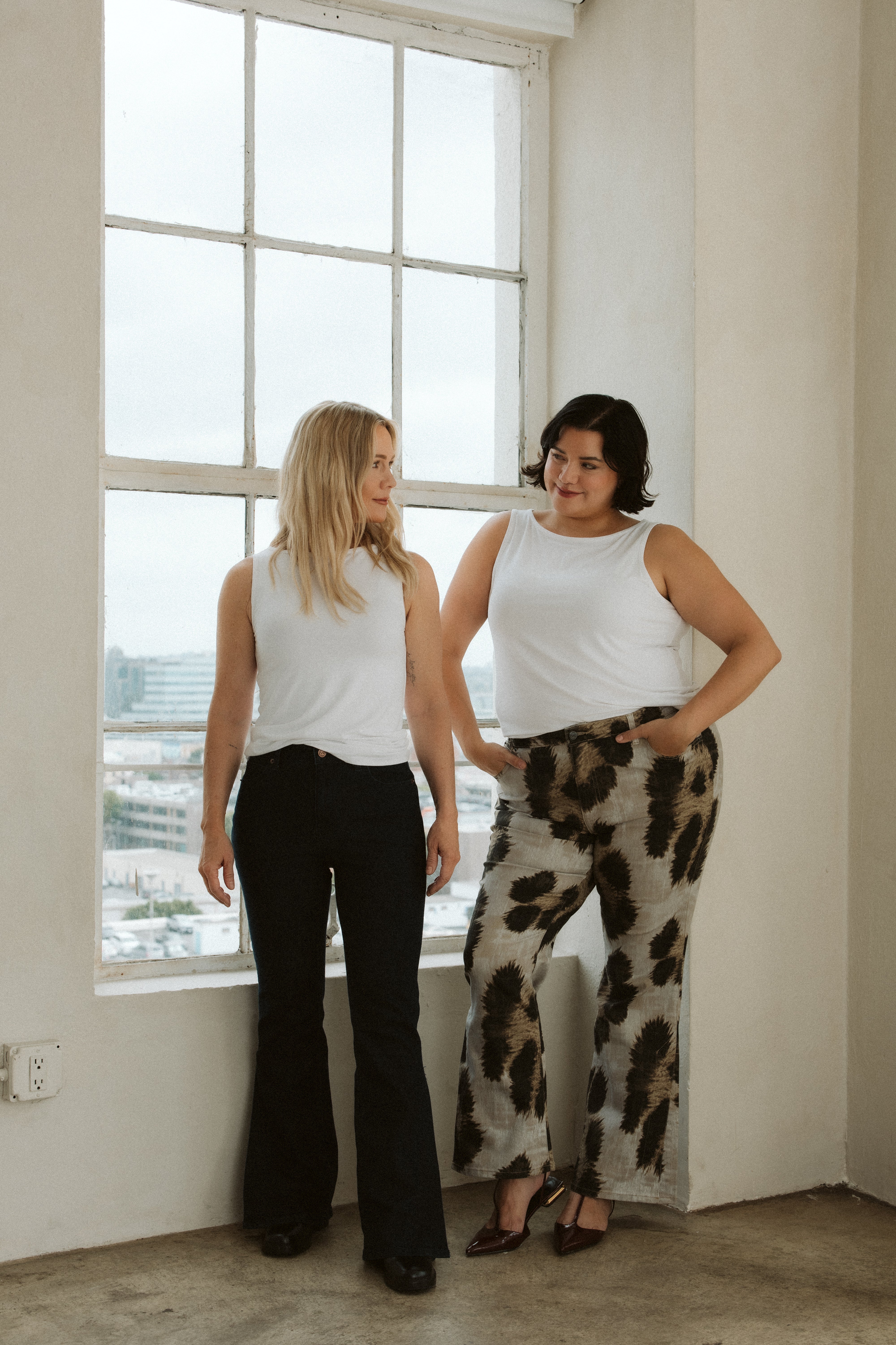 Jennie Garth modeling her clothing brand Me By Jennie Garth for QVC in her City Flare Cheetah Jeans with her plus size model.